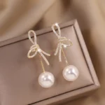 Elegant-Micro-Zircon-Setting-Bowknot-Pearl-Dangle-Earring-For-Women-Exquisite-Advanced-Design-Young-Girl-Gold.webp